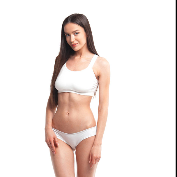 Slim young woman in underwear on white background. Skin and body care concept - Foto, Imagem