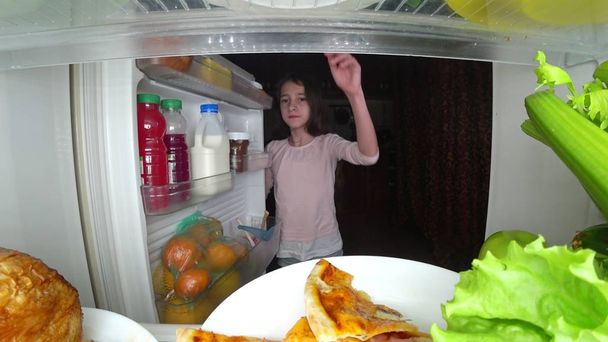 girl teenager opens the refrigerator at night. night hunger. diet gluttony - Foto, immagini