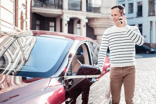 Delighted man opening his car - 写真・画像