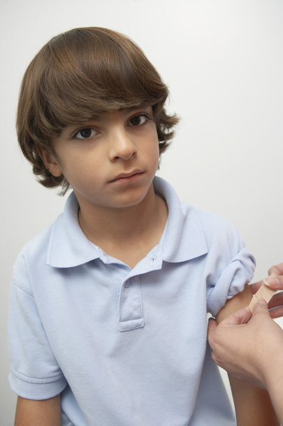 Hands Applying Bandage On Boy's Arm - Foto, immagini