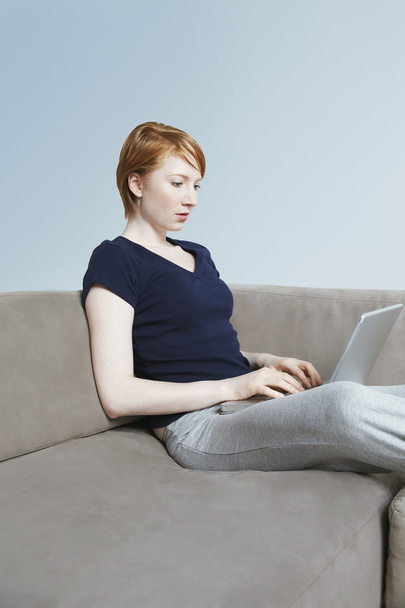 Female Using Laptop At Home - Foto, immagini