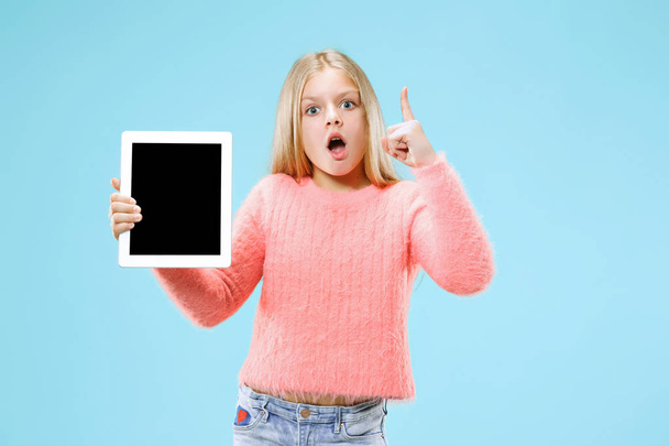 Little funny girl with tablet on blue background - Fotografie, Obrázek