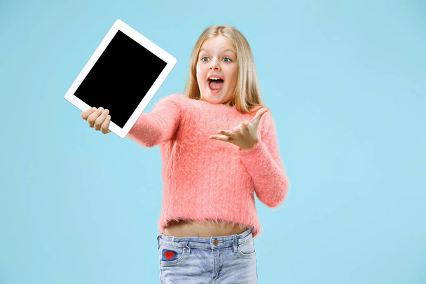 Little funny girl with tablet on blue background - Foto, Bild