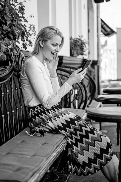 Make appointment. Woman enthusiastic face with smartphone create appointment in social network and wait friends cafe terrace. Girl wait meeting with friends. Arrange appointment in social network - Zdjęcie, obraz