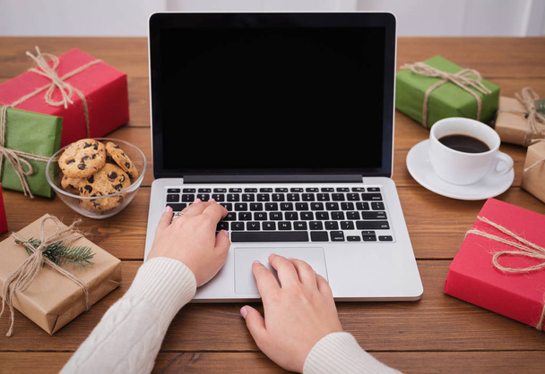 Preparing for Christmas. Woman buying presents on laptop, copy space - Фото, зображення