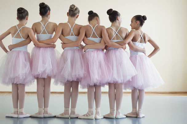 Group of ballerinas posing together with back to camera - Foto, afbeelding