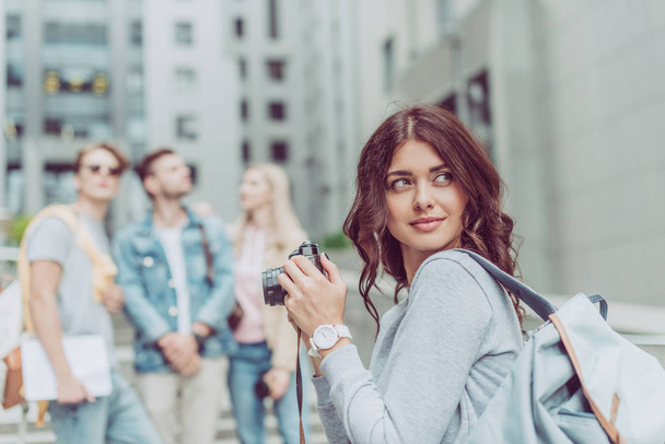 beautiful female photographer with camera in city with friends - Fotografie, Obrázek