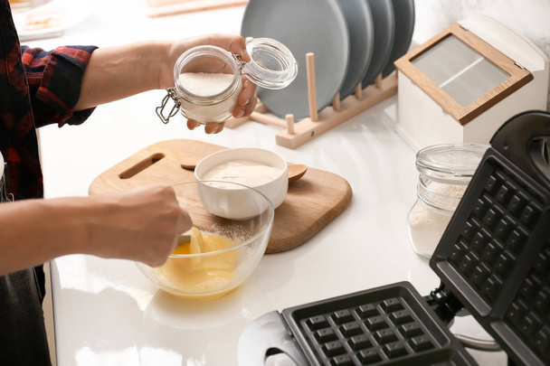 Woman making dough for waffles in kitchen - Photo, Image