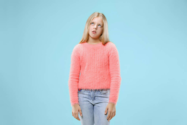 Beautiful bored teen girl bored isolated on blue background - Foto, Imagen