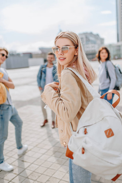 young stylish girl walking in city with friends - Photo, Image