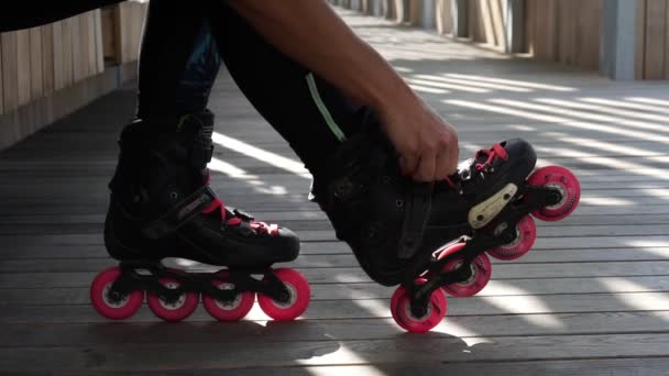 Woman shoes roller skates, close-up. - Footage, Video