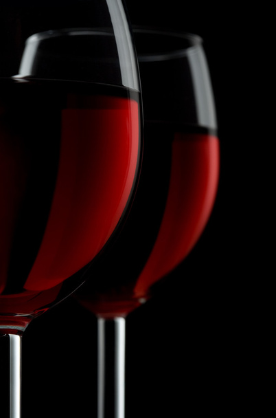 Two glassed of red wine isolated on black background - Foto, Imagem