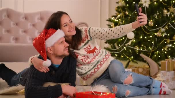 Portrait of Happy Couple. They Are Doing Selfie and Smiling Together. Happy New Year and Merry Christmas Concept. - Materiaali, video