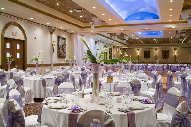 Indoor wedding reception hall with round tables and floral cent - Photo, Image