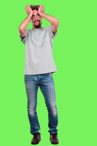 Young bearded man full body gesturing against chroma key green background. Ready to cut out. - Foto, Bild