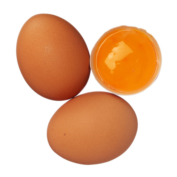 Целые яйца и яичный желток в скорлупе изолированы на белом
 - Фото, изображение