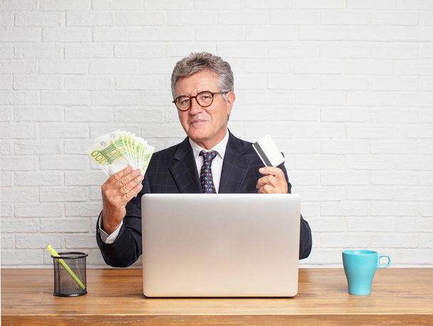 senior businessman working with his laptop. Money concept. - Фото, зображення