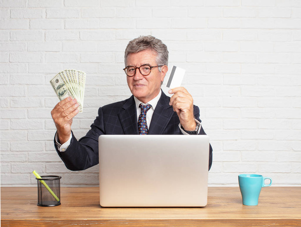 senior businessman working with his laptop. Money concept. - Photo, Image