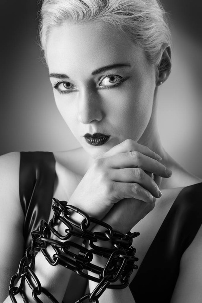Studio black and white image of young woman wearing latex - Foto, Imagen