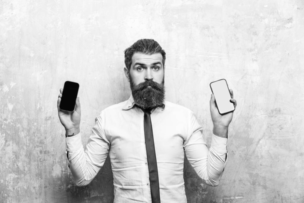 hipster or bearded man compare mobile phone and smartphone - Photo, Image