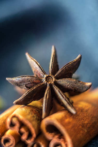 Star anise and cinnamon on a blue background, close-up - Foto, imagen