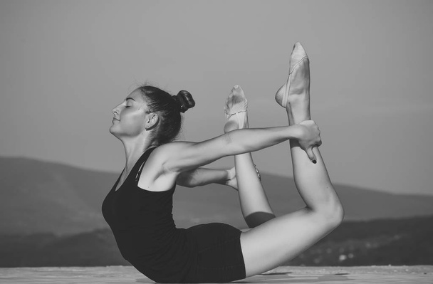 pilates workout of girl on blue sky background. - Φωτογραφία, εικόνα