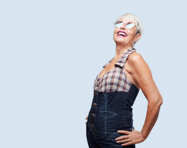 senior cool woman Laughing out loud with head tilted backwards and happy, cheerful expression - Photo, image