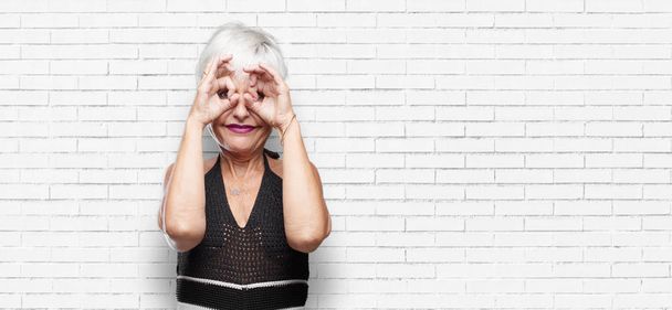 senior cool woman rubbing eyes in surprise and disbelief, amazed or frightened, possibly crying. - Fotoğraf, Görsel