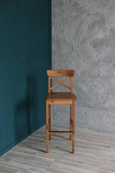 Wooden chair on a gray wall background. minimalistic concept. Interior design. - Foto, afbeelding
