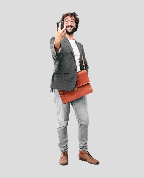 young bearded businessman wearing blazer using a smartphone - Fotografie, Obrázek