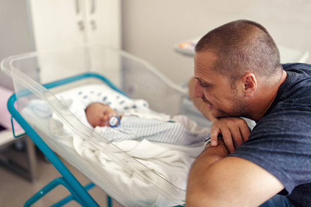 tender moment between a father and his newborn baby boy - Фото, зображення