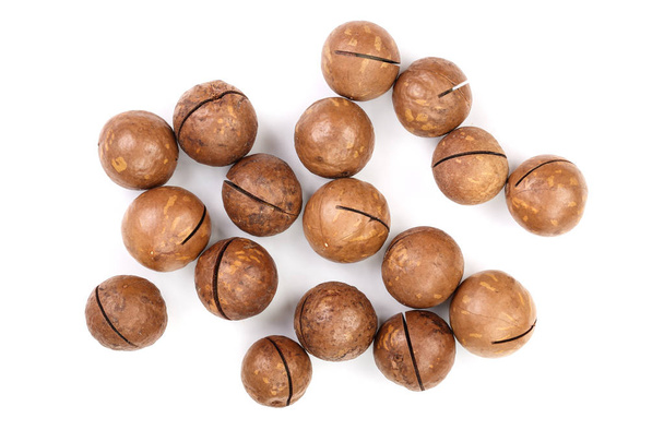 unshelled macadamia nuts isolated on white background. Top view. Flat lay pattern - Фото, зображення