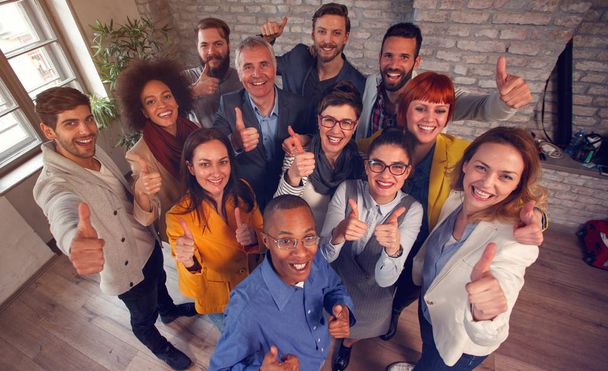 Group of smiling success business team giving thumbs up - Foto, Bild