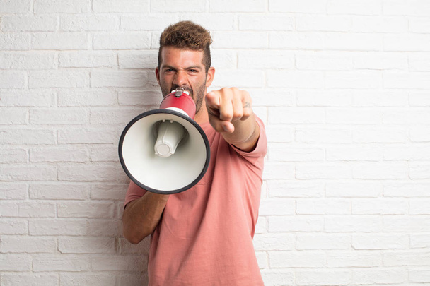 young handsome cool man holding a megaphone - Photo, image