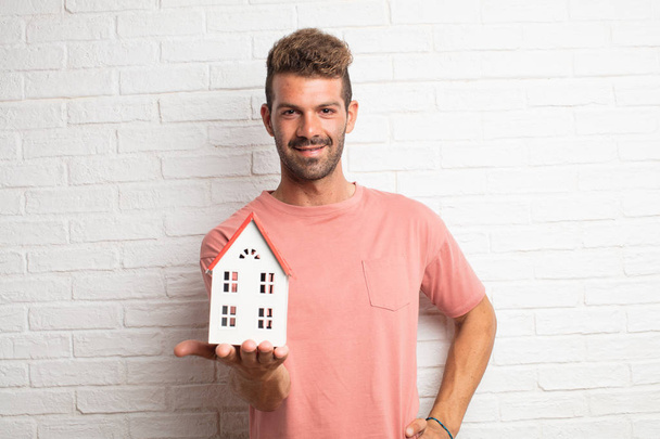 young handsome cool man holding a house model - Foto, Imagem