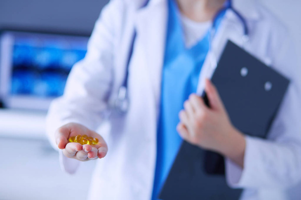 Close-up shot of doctors hands holding pills. - Фото, изображение