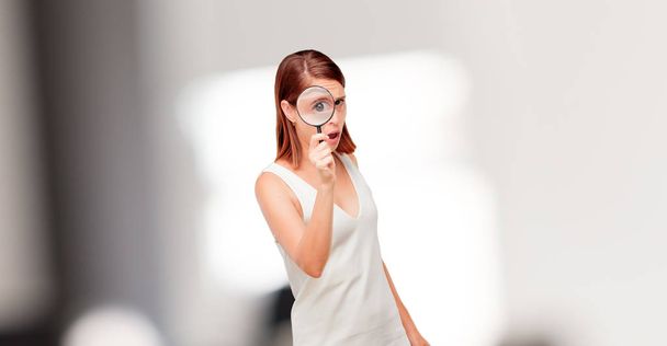 young pretty woman with a magnifying glass - Zdjęcie, obraz