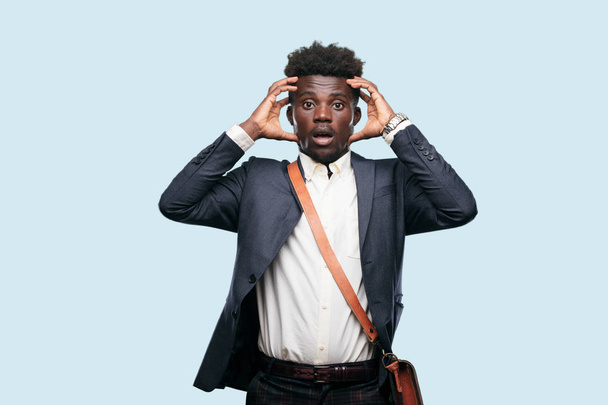 young black businessman with a crazy, amazed look of surprise, holding head with both hands, pulling hair. - Photo, Image