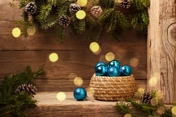 Winter holidays background with fir tree branch blue decorations on rustic old wood - Photo, Image