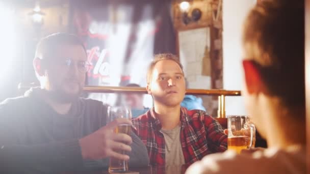 Trzech młodych mężczyzn, siedząc w irlandzkim pubie picia piwa - Materiał filmowy, wideo