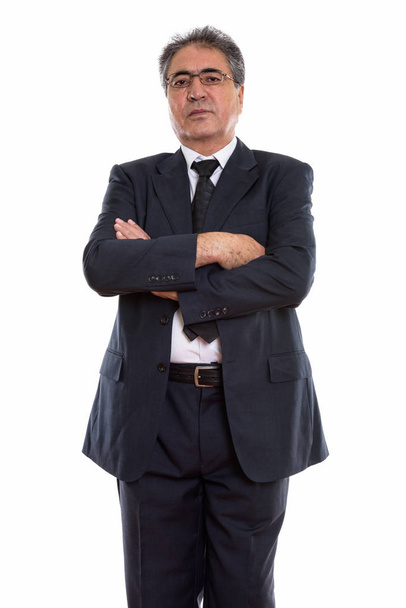 Studio shot of senior Persian businessman standing and wearing e - Zdjęcie, obraz