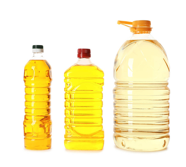 Different plastic bottles with oils on white background - Foto, Imagen