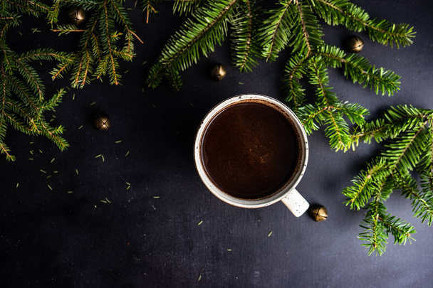 Cup of coffee on dark wooden background with holiday decor and copy space - Photo, Image