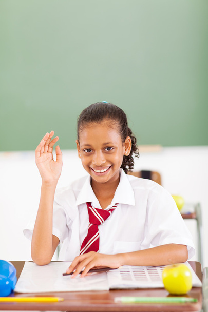primary schoolgirl hand up in classroom - Photo, Image