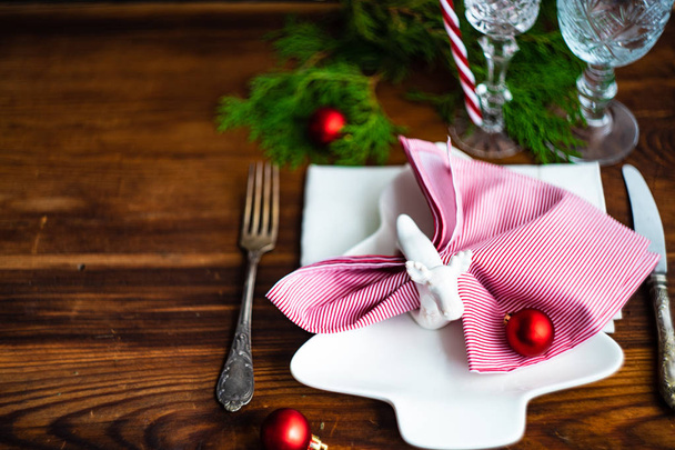 Festive table setting for Christmas dinner on vintage wooden table with copy space - Fotó, kép