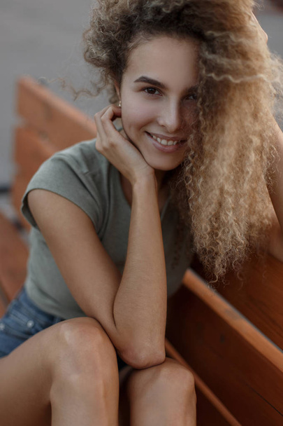 Happy portrait of a young funny curly girl outdoors - Foto, Bild