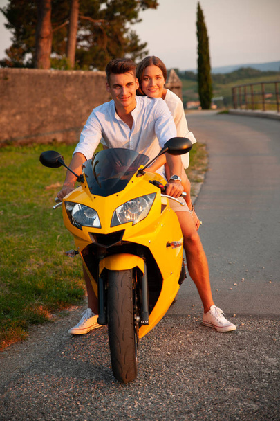Young couple on a motor bike on a late summer afternoon - Φωτογραφία, εικόνα