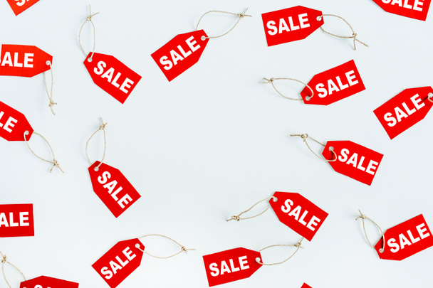 Black Friday sales discount concept. Frame of red tags with word sale on white background. Flat lay, top view. - Fotó, kép