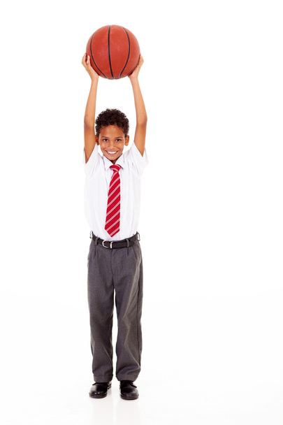 Little schoolboy holding a basket ball isolated on white - Foto, immagini
