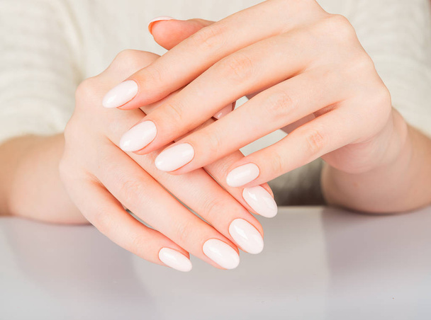 Beautiful female hand with beige nail design - Foto, immagini